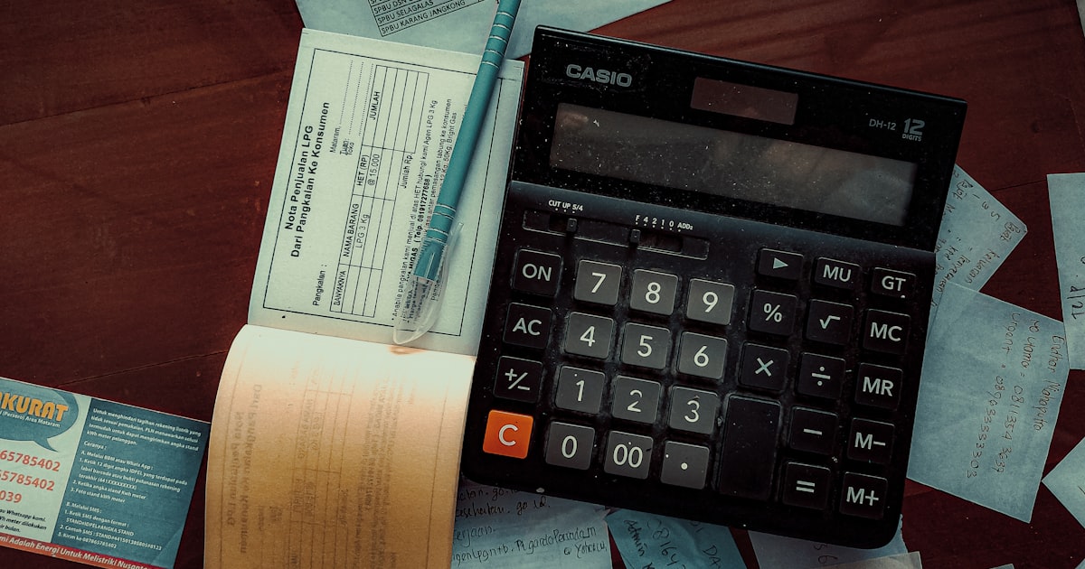 A calculator sitting on top of a wooden table — SARS invoice compliance